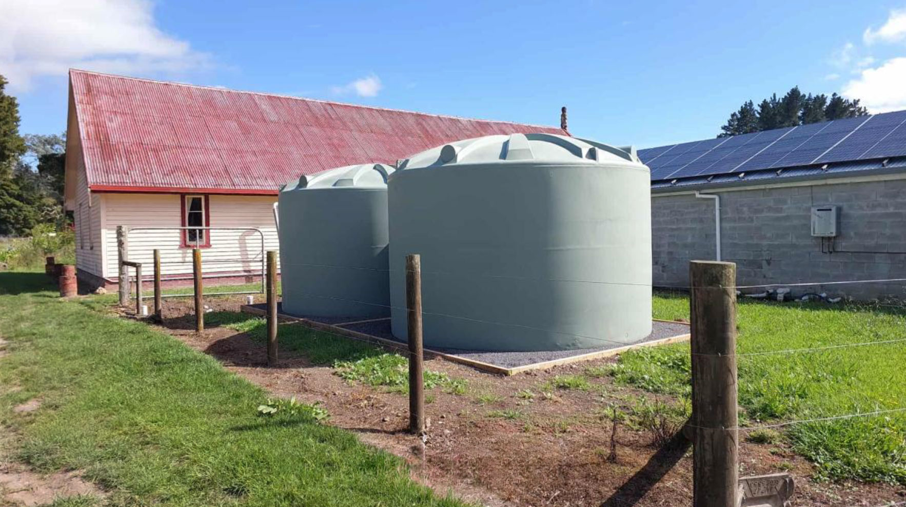wo large water tanks in front of a building.