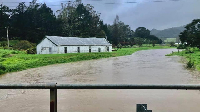 A building beside a river in flood