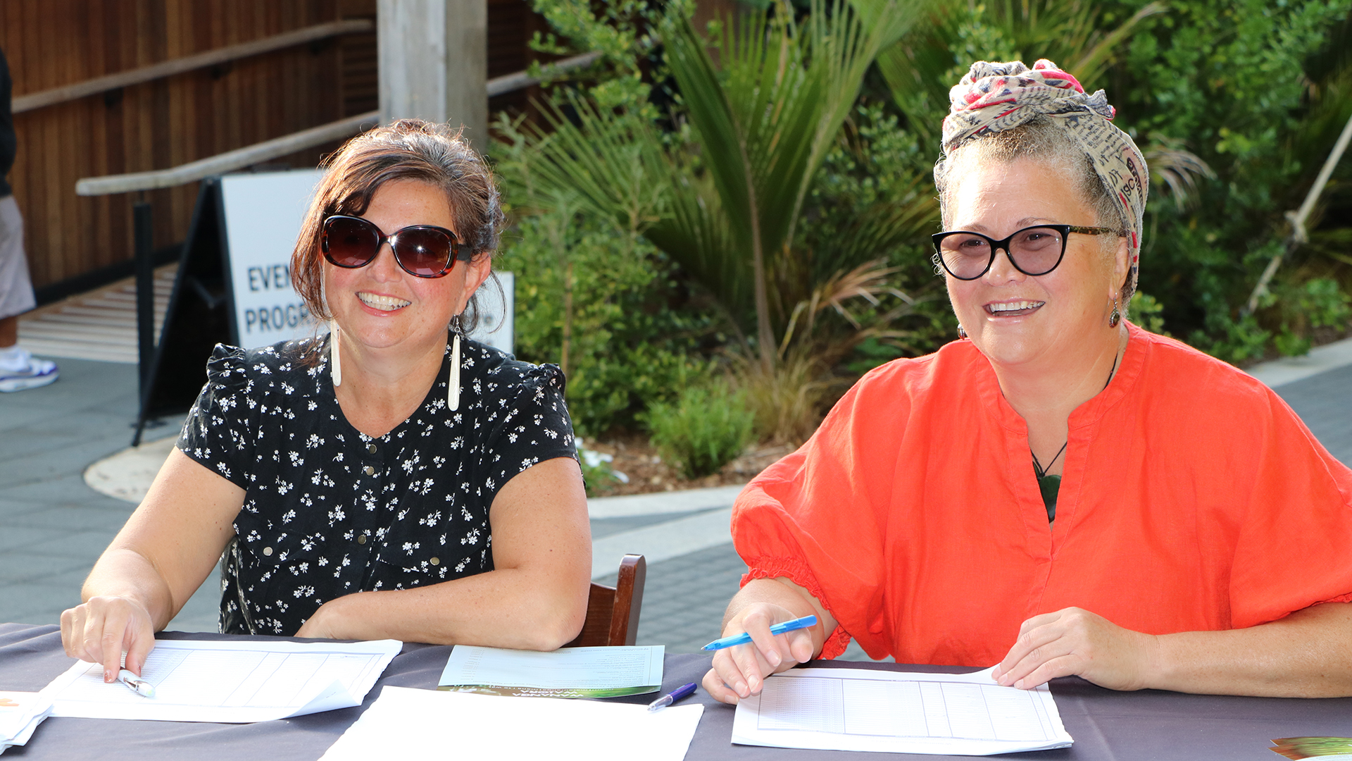 NRC staff sitting at the registration table at the 2025 Wananga Waiora.