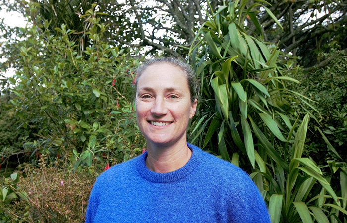 Maree Stewart standing in front of a garden in the park.