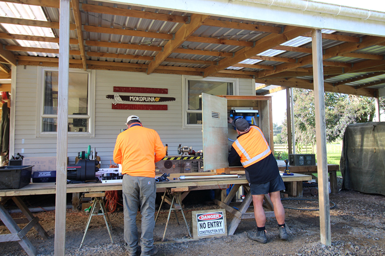 Kaikohe project leads work hard fitting out pump boxes with water tanks