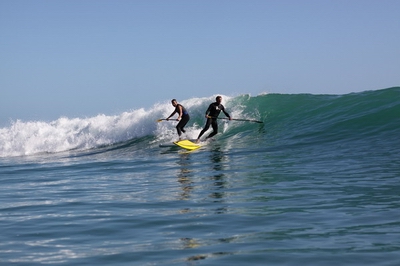 Two surfers on paddleboards. Two surfers on paddleboards.
