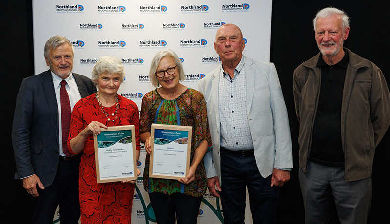 Two women hold certificates, while three men stand alongside in front of Northland Regional Council logo backdrop. (Photo: Dawn Dutton Photography).