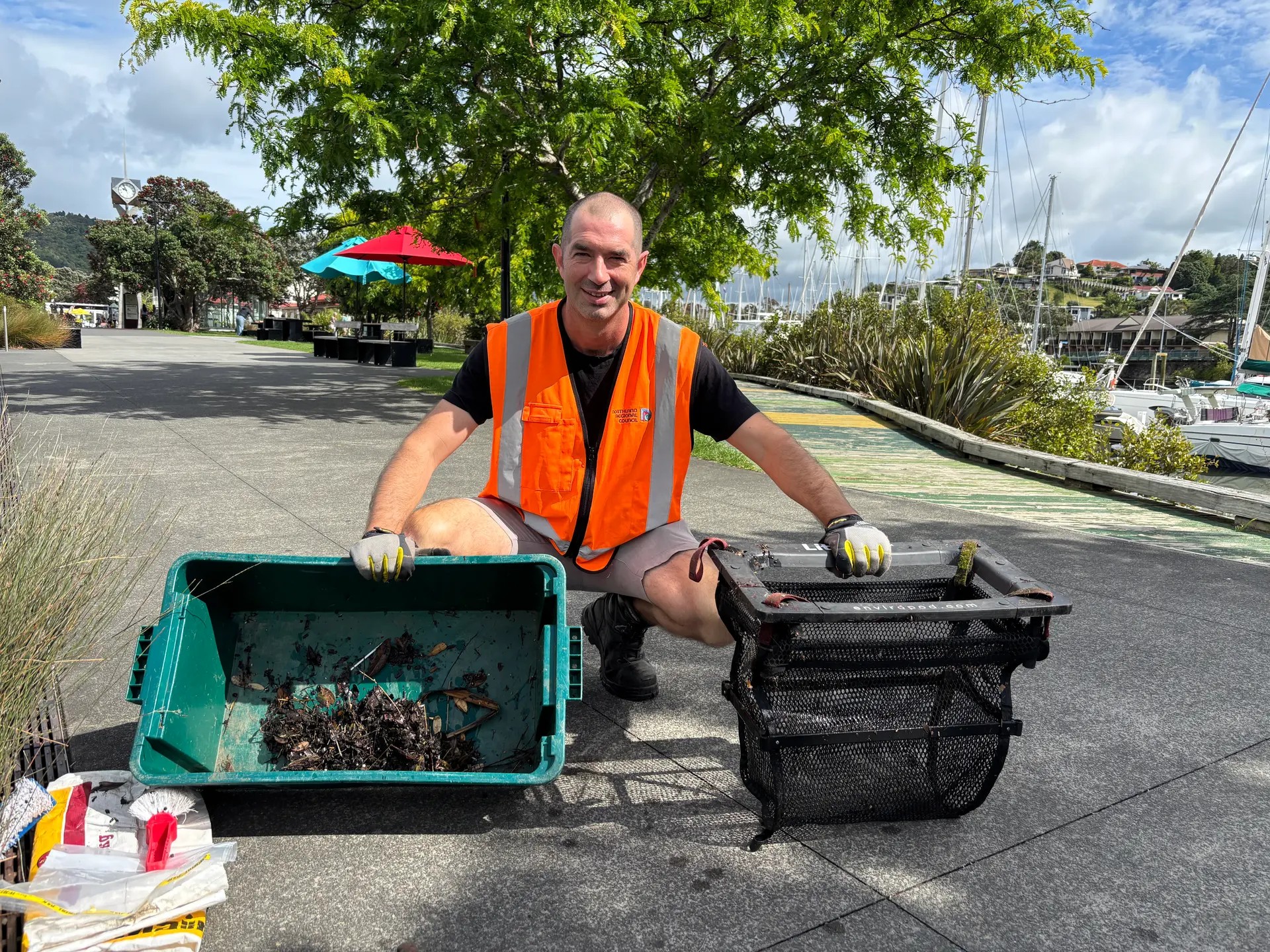 Richie Griffiths with a littatrap and its contents (photo RNZ.co.nz) 