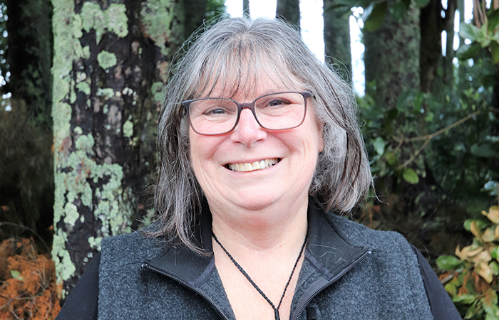 Morag Vasilaki standing in front of a trees in the park.