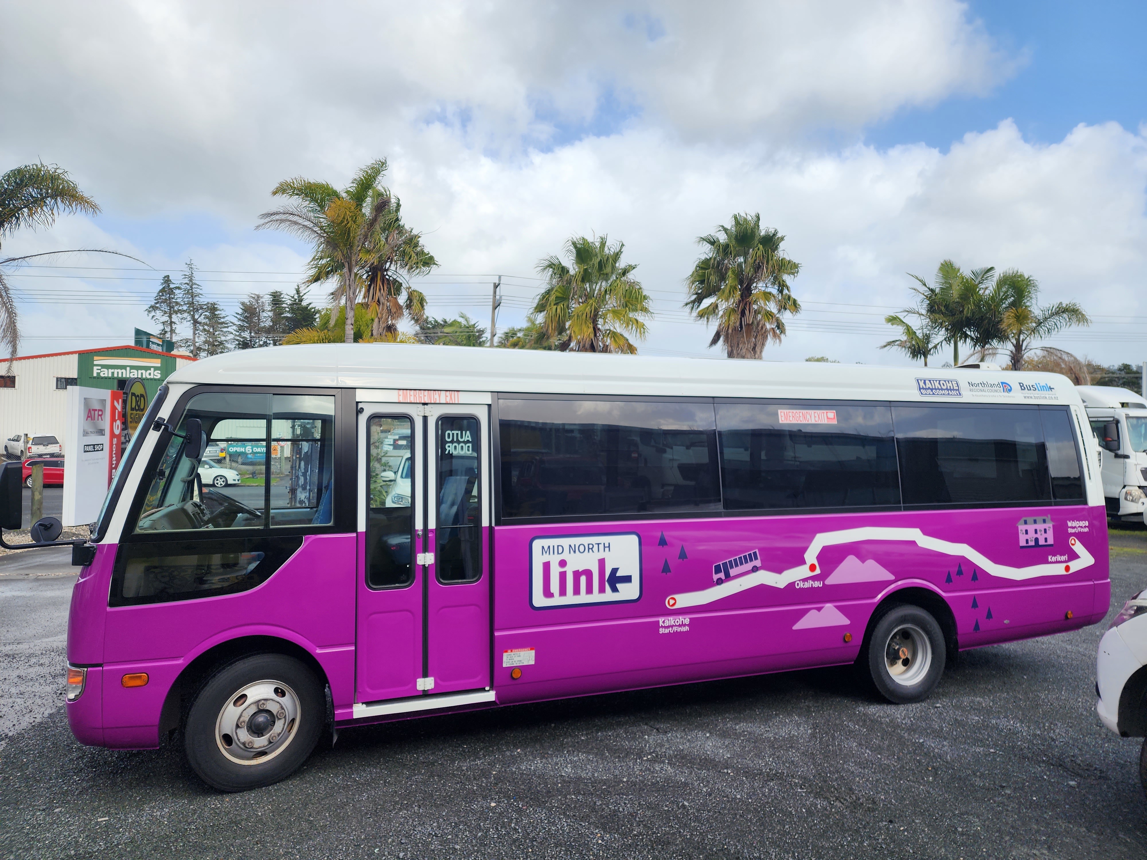 Purple BusLink bus parked on a street 