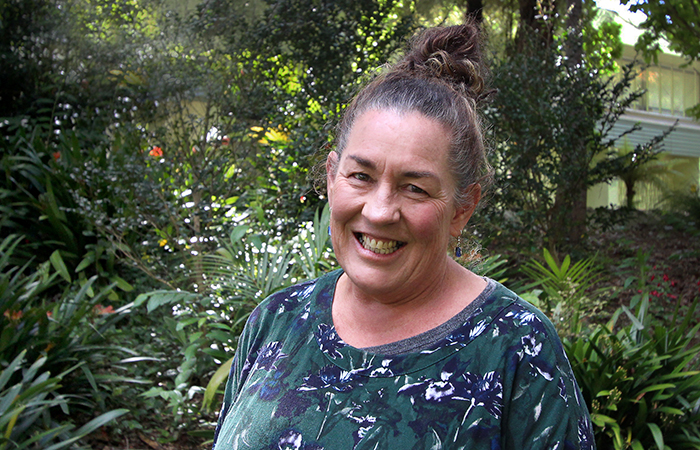 Judy Crooks standing in front of a garden in the park.